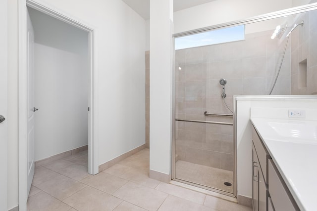 bathroom with vanity, tile patterned flooring, and a shower with door