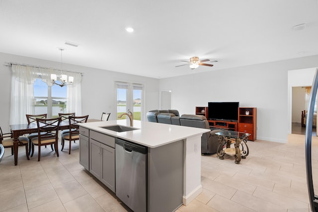 kitchen featuring sink, ceiling fan with notable chandelier, dishwasher, an island with sink, and decorative light fixtures