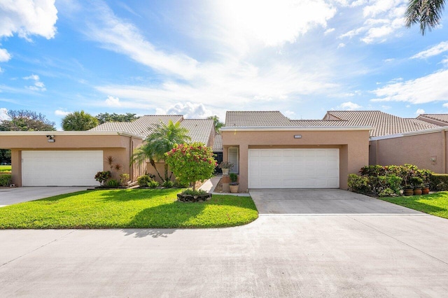 view of front of property featuring a garage and a front lawn