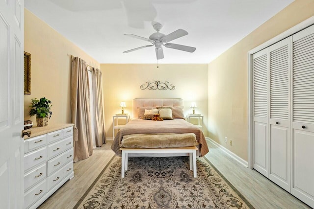 bedroom featuring ceiling fan, a closet, and light wood-type flooring