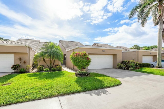 view of front of house with a garage and a front lawn