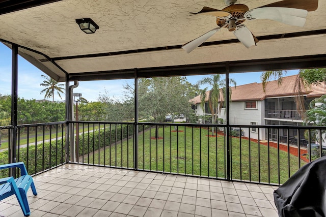 unfurnished sunroom featuring ceiling fan