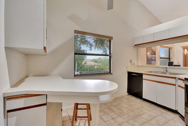 kitchen with light tile patterned flooring, sink, a breakfast bar area, dishwasher, and white cabinets