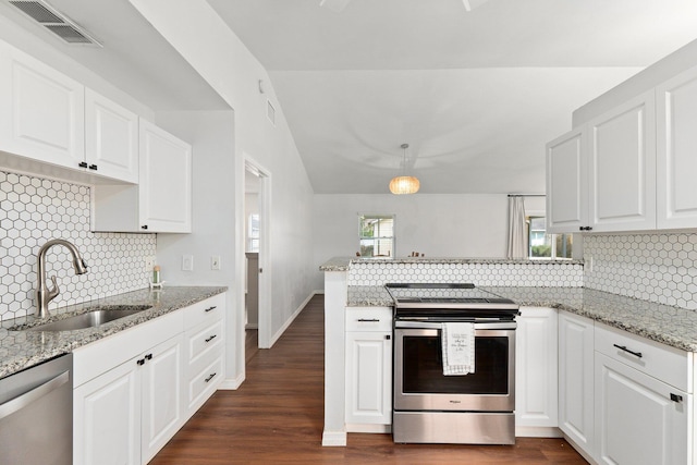 kitchen featuring stainless steel appliances, white cabinetry, sink, and decorative light fixtures