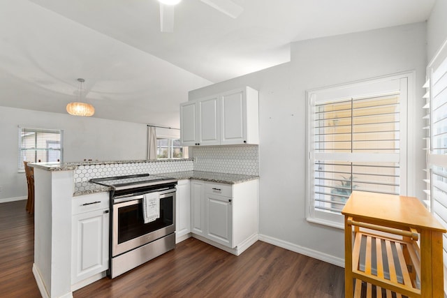 kitchen featuring kitchen peninsula, stainless steel electric stove, white cabinets, and light stone countertops