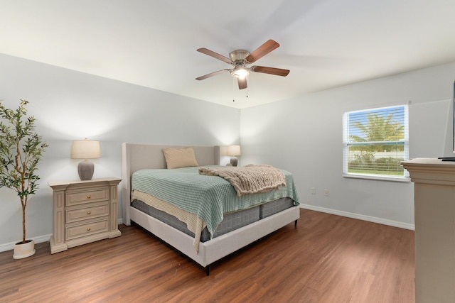 bedroom with dark hardwood / wood-style floors and ceiling fan