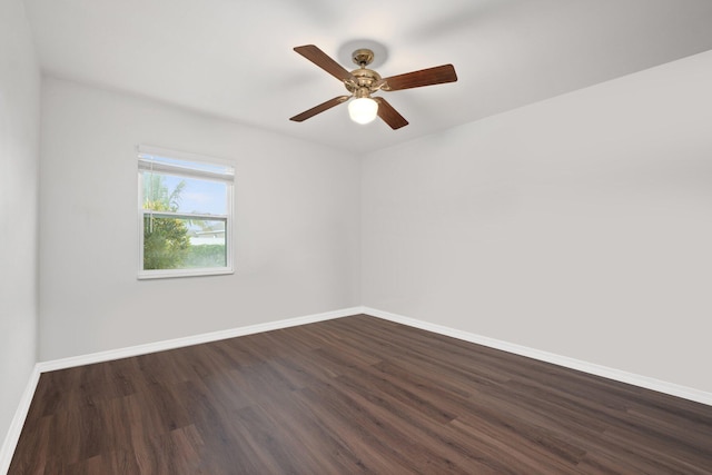 empty room with dark wood-type flooring and ceiling fan