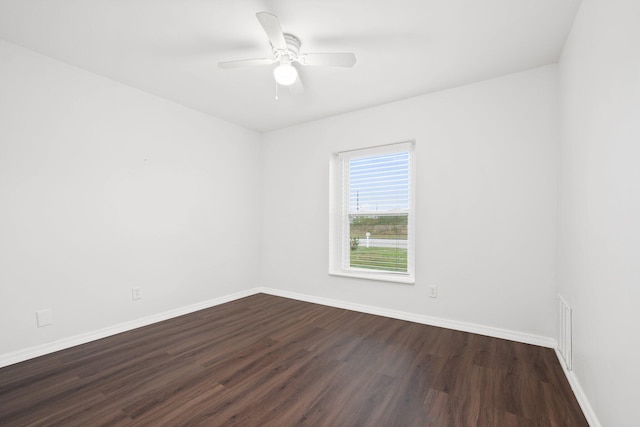 spare room with ceiling fan and dark hardwood / wood-style floors