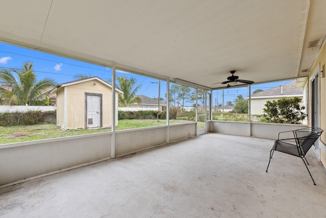 unfurnished sunroom featuring ceiling fan