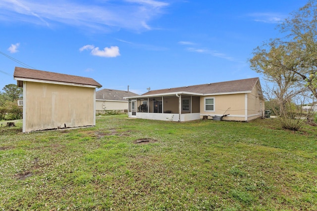 back of property with a sunroom and a yard