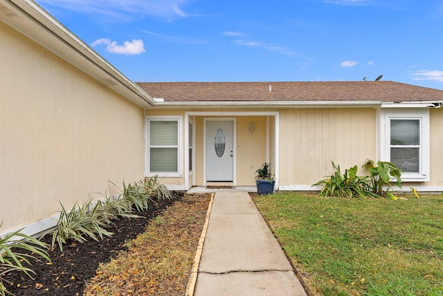 doorway to property featuring a yard