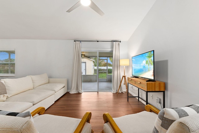 living room featuring dark wood-type flooring, plenty of natural light, lofted ceiling, and ceiling fan