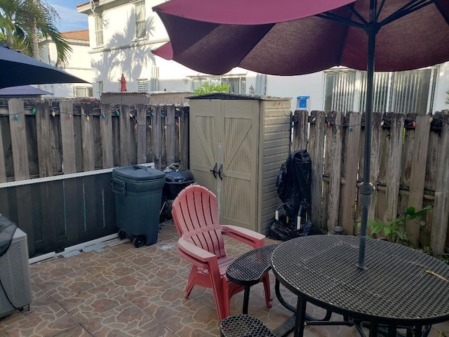 view of patio / terrace featuring a storage unit