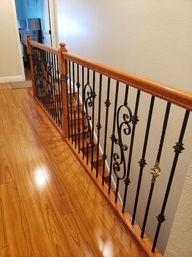 stairway with hardwood / wood-style floors