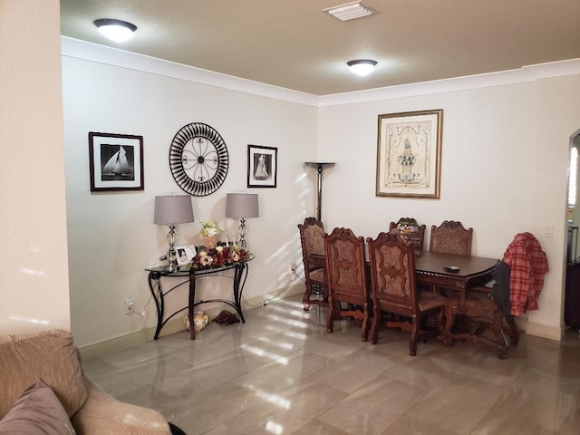 dining space with ornamental molding