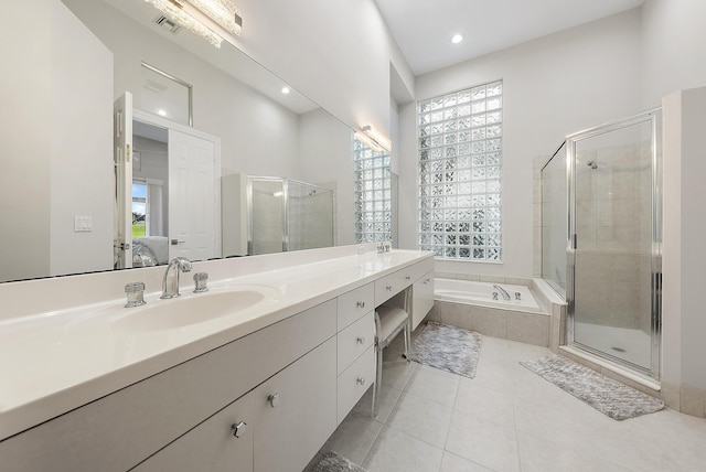 bathroom featuring vanity, tile patterned floors, and shower with separate bathtub