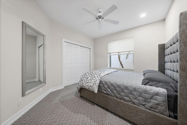 carpeted bedroom with ceiling fan and a closet