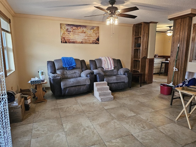 living room with decorative columns, ceiling fan, ornamental molding, a textured ceiling, and light tile patterned flooring