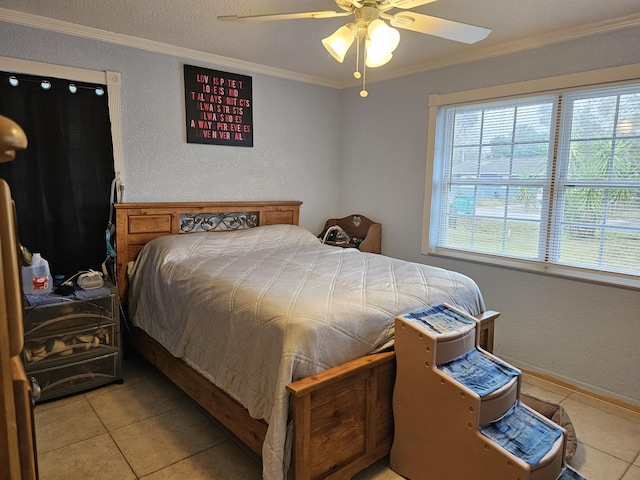 bedroom with a textured ceiling, ornamental molding, a ceiling fan, and light tile patterned flooring