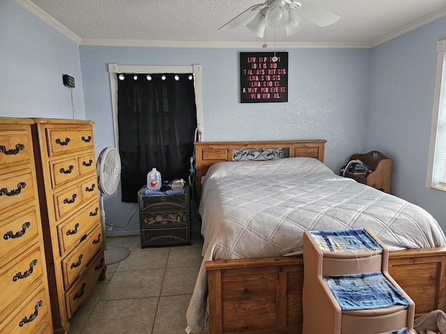 bedroom featuring a ceiling fan, tile patterned flooring, crown molding, and a textured ceiling