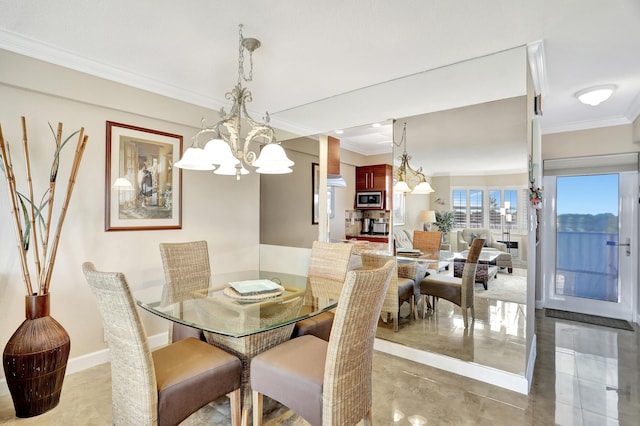 dining area featuring crown molding and a notable chandelier