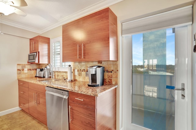 kitchen featuring crown molding, appliances with stainless steel finishes, sink, light stone counters, and decorative backsplash