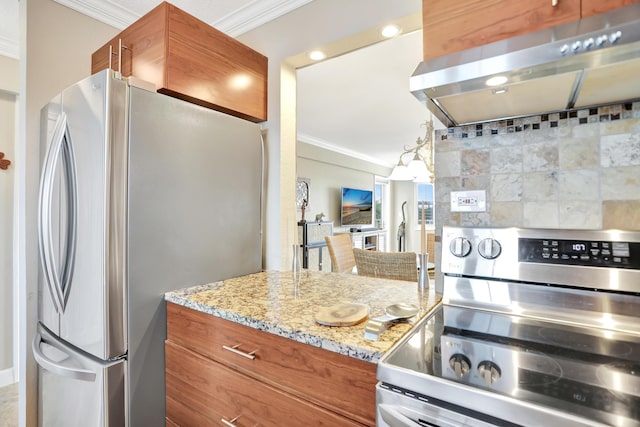 kitchen with hanging light fixtures, light stone countertops, exhaust hood, ornamental molding, and stainless steel appliances