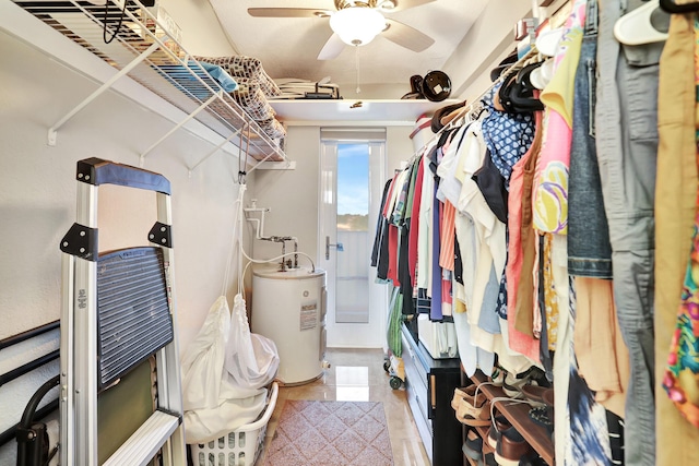 spacious closet featuring ceiling fan and water heater