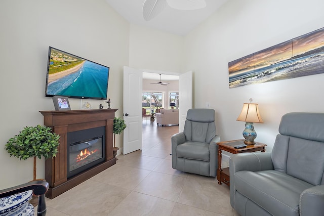 tiled living room with a high ceiling and ceiling fan