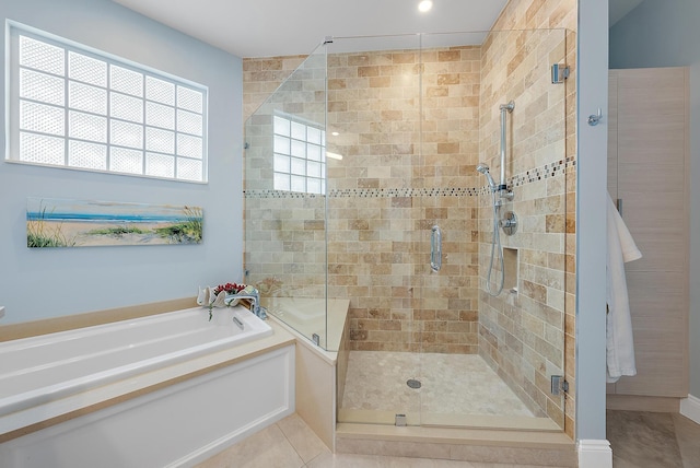 bathroom with separate shower and tub