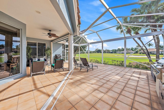 unfurnished sunroom featuring ceiling fan