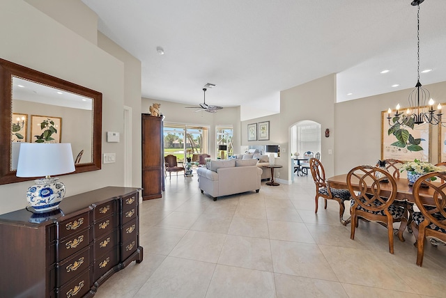 tiled living room featuring ceiling fan with notable chandelier