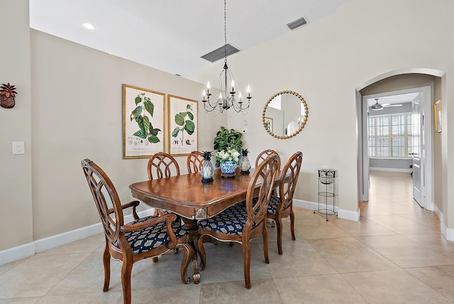 tiled dining space featuring ceiling fan with notable chandelier