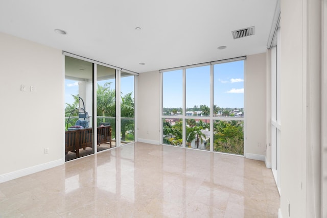 spare room with floor to ceiling windows