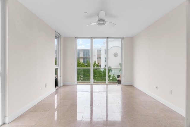 unfurnished room with floor to ceiling windows and ceiling fan