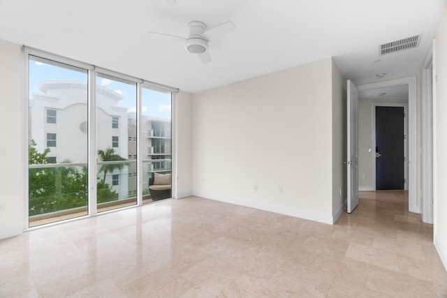 unfurnished room featuring floor to ceiling windows and ceiling fan