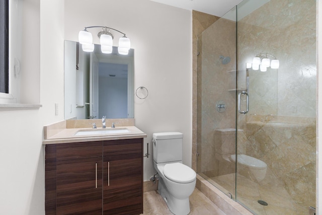 bathroom featuring vanity, an enclosed shower, and toilet