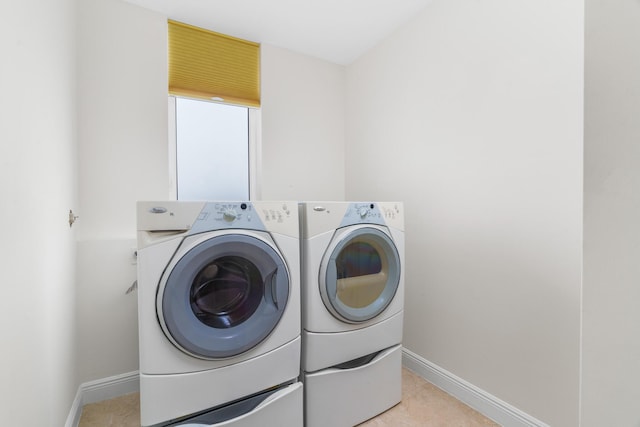 washroom featuring washing machine and clothes dryer and light tile patterned flooring