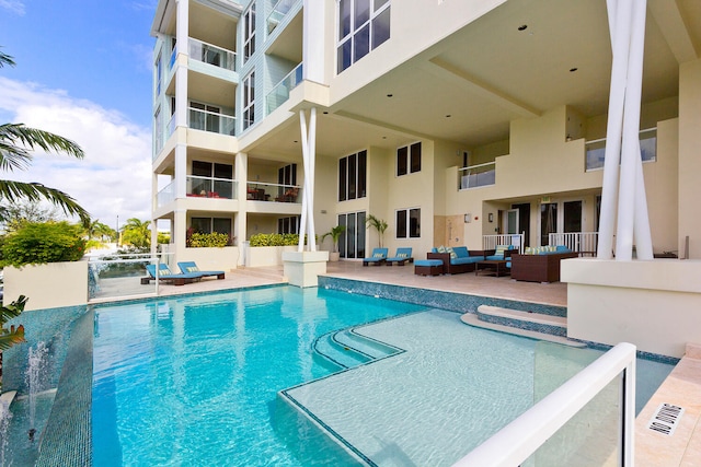 view of pool featuring outdoor lounge area and a patio