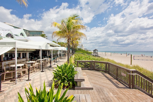 wooden terrace with a beach view and a water view