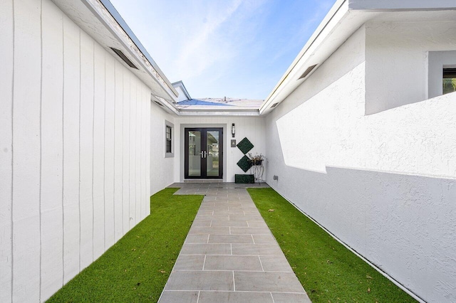 view of exterior entry featuring a patio area and french doors