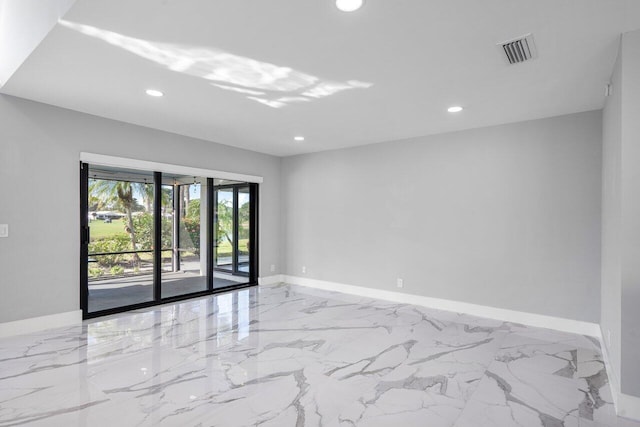 spare room with marble finish floor, baseboards, visible vents, and recessed lighting