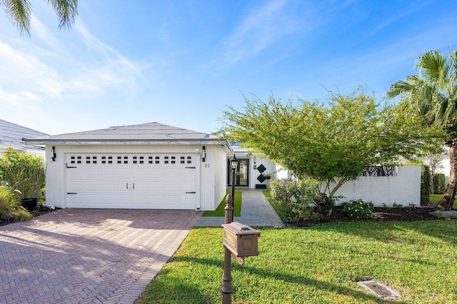 51 Woods Ln, Boynton Beach, FL 33436 - single story home with decorative driveway, a front lawn, and a garage
