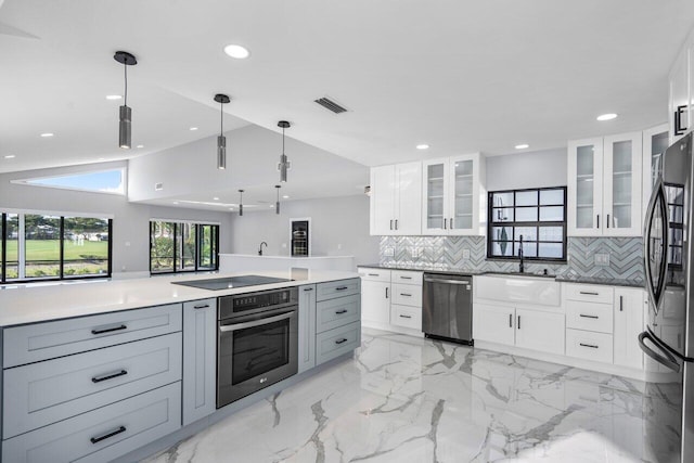 kitchen featuring gray cabinetry, white cabinetry, tasteful backsplash, pendant lighting, and stainless steel appliances