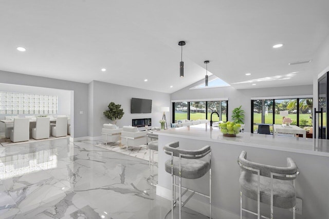51 Woods Ln, Boynton Beach, FL 33436 - kitchen featuring recessed lighting, open floor plan, light marble finish flooring, a kitchen bar, and light countertops