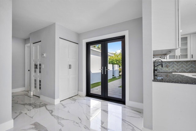 foyer featuring sink and french doors