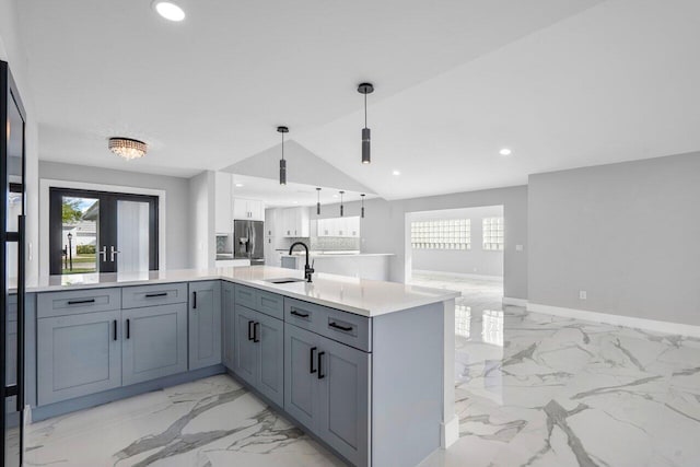 kitchen with pendant lighting, sink, gray cabinets, stainless steel fridge with ice dispenser, and french doors