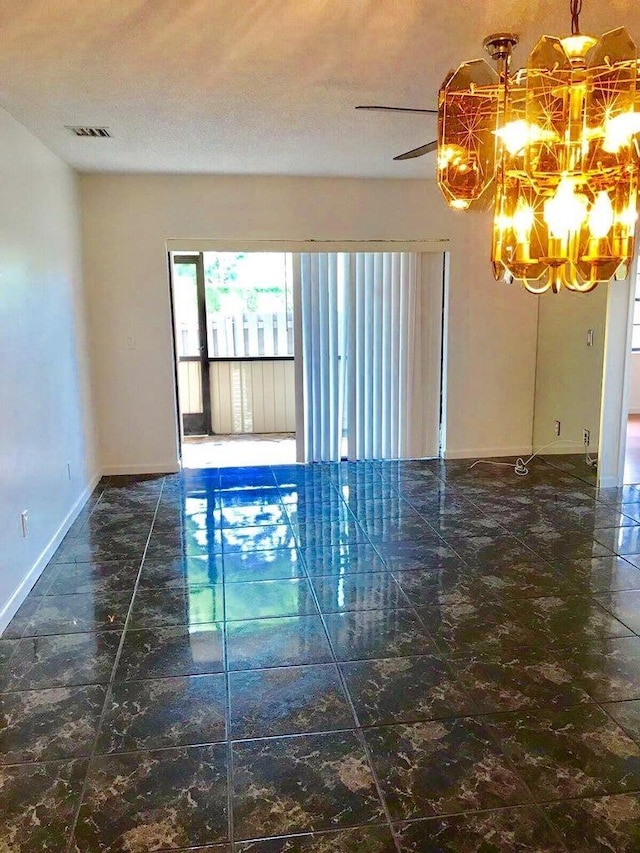 spare room featuring a textured ceiling and a chandelier