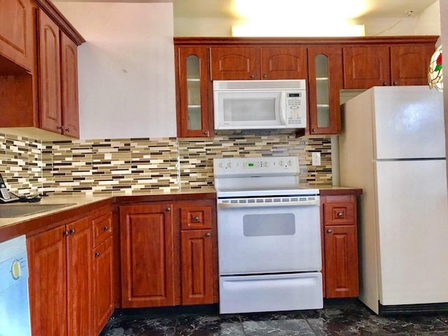 kitchen with sink, backsplash, and white appliances