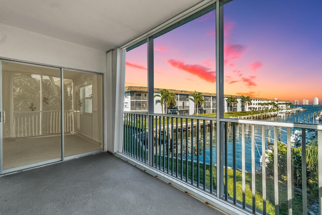 236 Castlewood Dr Unit 208, North Palm Beach, FL 33408 - balcony at dusk featuring a water view